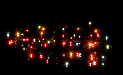 Glittering lights Christmas garland isolated on black