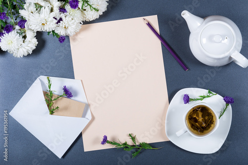 Download Elegant Still Life Sheet Of Paper White And Purple Chrysanthemums Pencil Teapot Cup Of Herbal Tea And Envelope On Gray Background Space For The Text Light Romantic Mockup Top View PSD Mockup Templates