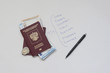© Александр Овсянников - Russian passport with euro banknotes on a white sheet with inscriptions of European countries. Planning your trip on vacation.