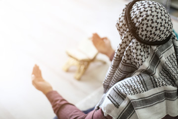 Wall Mural - Young Muslim man praying, indoors