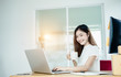 © jumlongch - Young asian girl is freelancer with her private business at home office, working with laptop, coffee, online marketing, Customer order and packaging or packing.
