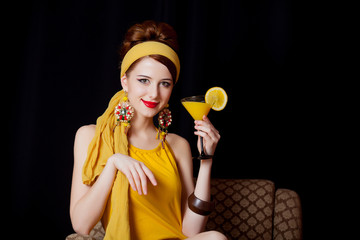 Poster - girl in 70s clothes style sitting in armchair with cocktail