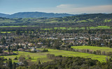 Fototapeta  - An Aerial View of the Sonoma Valley on Sunny Afternoon Shows the Town Nestled Among the Surrounding Hills and Mountains