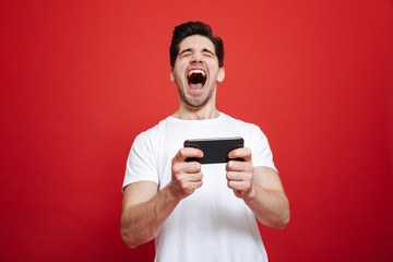 Poster - Portrait of a happy young man in white t-shirt celebrating