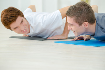 Two young men doing press ups