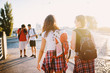 © dusanpetkovic1 - Two tourist girl walking to the two male friends on the street.