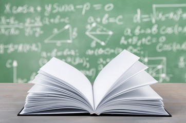 Wall Mural - Book on desk on formulas background