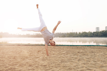 Wall Mural - Casual athletic man on the beach while workout