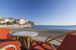 © joan_bautista - Beach and terrace bar view of maritime french village of Banyuls-sur-mer,Cote Vermeille,Occitanie,France.