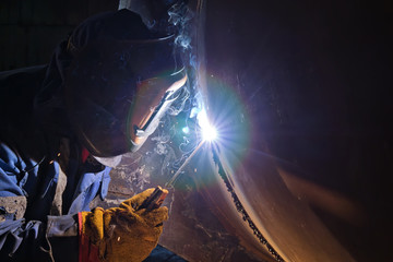 Canvas Print - Welding works on metal  heat exchanger using manual arc welding