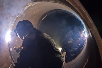 Canvas Print - welder weld root weld from inside of big pipe