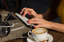Female Hands Typing On Retro Typewriter
