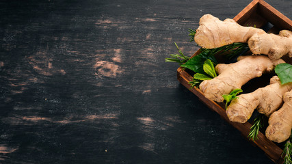 Wall Mural - Fresh ginger on a wooden background. Top view. Copy space.