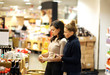 © lado2016 - Two women choosing a dairy products at supermarket.selective focus.