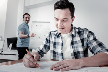 Wall Mural - Lets do it. Enigmatical man feeling happiness while looking downwards and doing his job