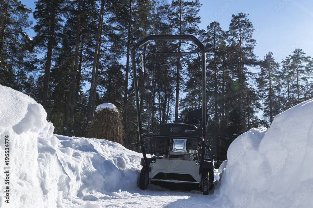 Remove Snow Machine Snowblower at work on a winter day. Snowplow removing snow after ...