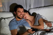 © Syda Productions - happy couple watching tv in bed at night at home