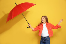 Young Woman With Red Umbrella On Color Background