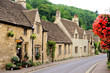 Picturesque street in the Cotswold village of Castle Combe, England with beautiful flowers