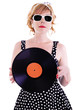 © michelaubryphoto - Attractive woman looks like a pinup, holding a vinyl record in her hands.