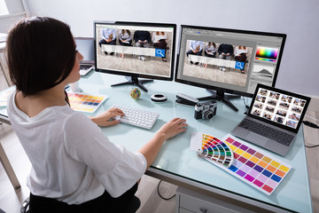 Poster - Female Designer Working On Multiple Computer