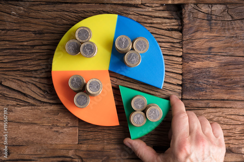 Fotomural Businessperson Taking Piece With Money From Pie Chart