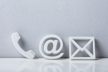 close-up of a phone, email and post icons
