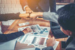 © Panumas - Businesspeople giving fist bump while working together. Teamwork Concept