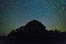 Old Barns With Starry Night  Sky With Clouds And Milky Way In Summer Time