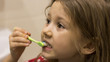 © Igorzvencom - Cute little girl washing her teeth