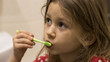 © Igorzvencom - Cute little girl washing her teeth