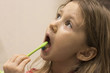 © Igorzvencom - Cute little girl washing her teeth