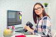 © fotofabrika - pretty young woman photographer with camera in office
