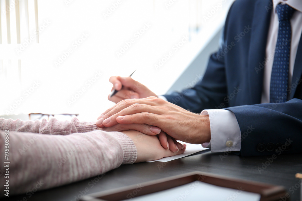 Lawyer having meeting with client in office, closeup