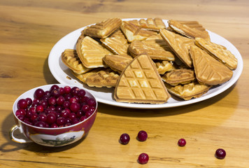 Delicious homemade cookies with berries on a wooden table