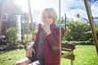© Wavebreak Media - Boy relaxing in swing on a sunny day