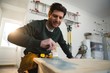 © Wavebreak Media - Male carpenter painting a table