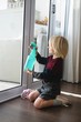 © Wavebreak Media - Boy cleaning window with rag cloth