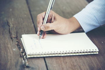 Close up woman hand writing on notebook.