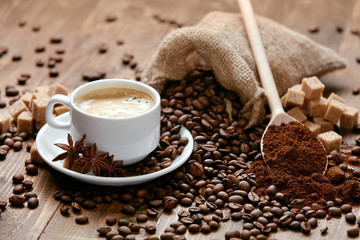 Cup Of Coffee And Coffee Beans On Table.