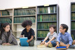 © Nattanon - Happy kids reading on the floor, Education lifestlye in the Library. Young people explore lifestlye in the Library. Development of Human Resources in Education Concept. Setup studio shooting.