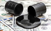 Whole Barrel Of Oil And Crude Oil Spilled From Barrel On The Dollar Bills.