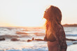 © marjan4782 - Young woman enjoying sunset and waves at the beach