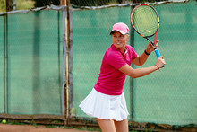 Tennis Player. Cheerful Active Woman Playing Tennis On The Court. Dressed In Pink T-shirt And White Skirt. Sport Concept.
