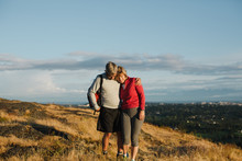 Fit, Active Middle Age Couple Hiking Together At Sunset
