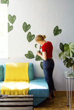 Woman Drawing Leaves On Wall