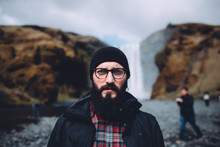 Portrait Of A Bearded Man In Front Of A Waterfall In Iceland