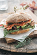 © Ina Peters/Stocksy - Food: smoked salmon sandwich with avocado,lettuce,card and dill