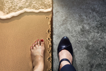 Life Balance concept for Work and Travel present in Top view position by half of Business Working Woman Shoes on Cement Floor and Female's Barefoot on Sand Beach