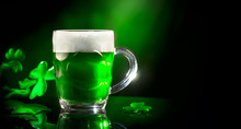 St. Patrick's Day. Green Beer Pint Over Dark Green Background, Decorated With Shamrock Leaves. Traditional Irish Festival
